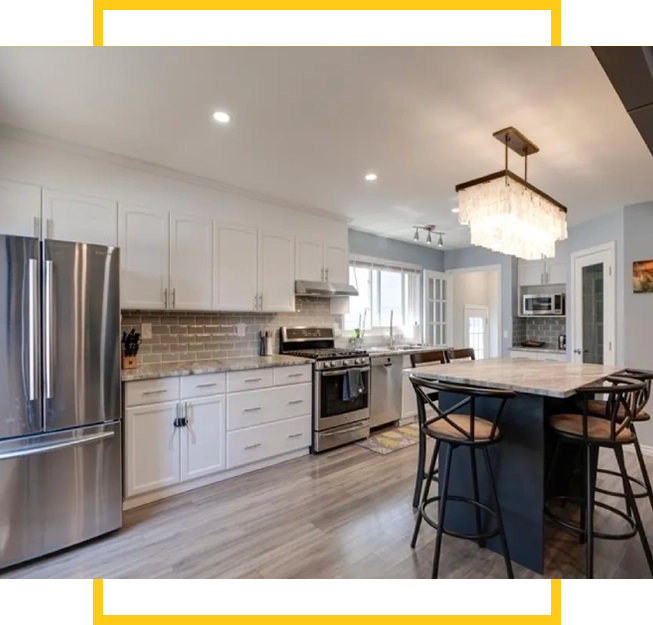 A kitchen with white cabinets and stainless steel appliances.